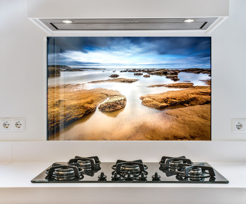 a stove top with a picture of a beach in the background