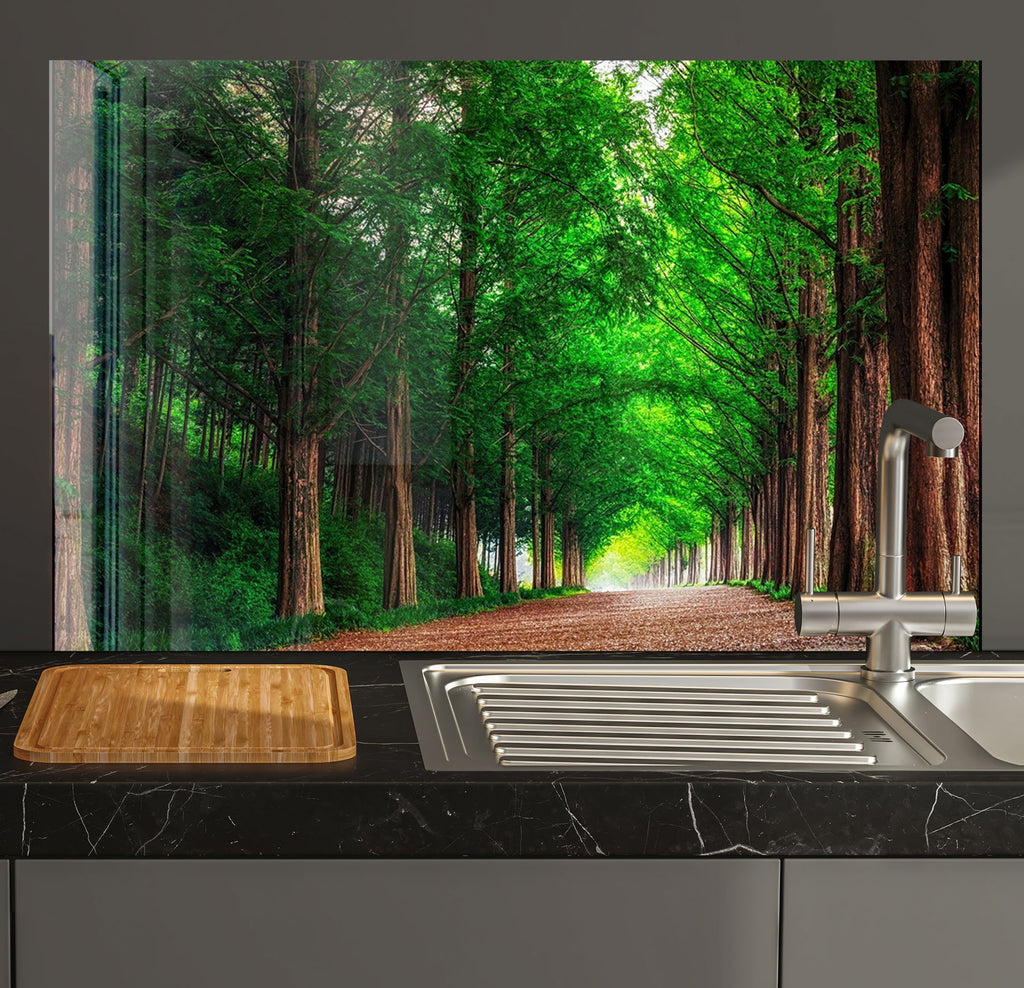 a kitchen sink sitting under a window next to a forest