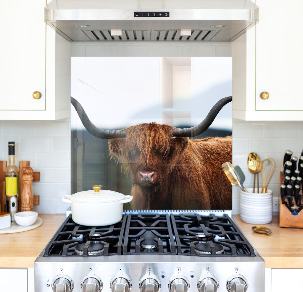 a picture of a cow is on the back of a stove