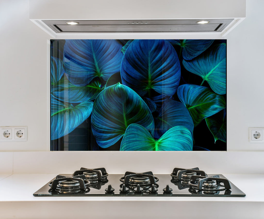 a picture of blue leaves on a wall above a stove