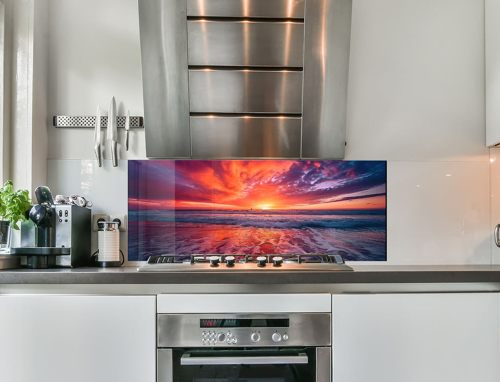 a kitchen with stainless steel appliances and a picture on the wall