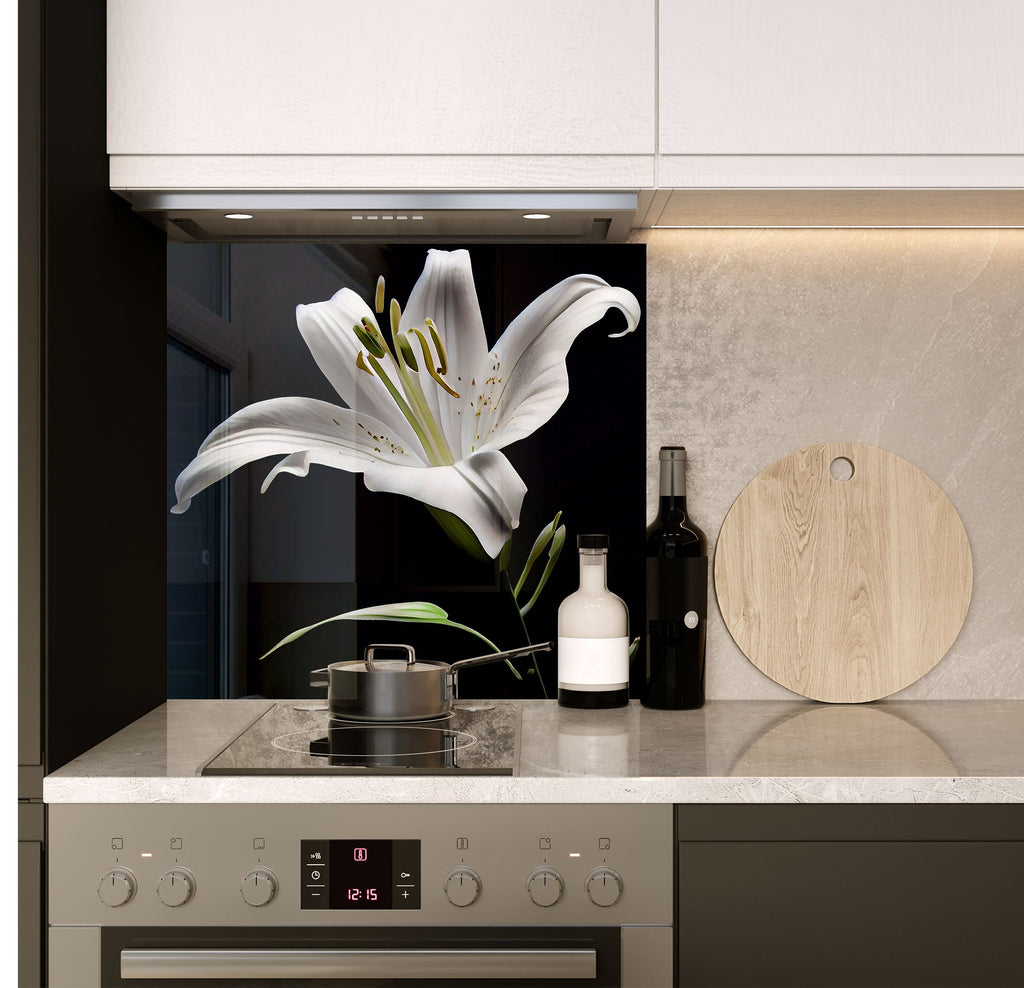 a white flower sitting on top of a kitchen counter