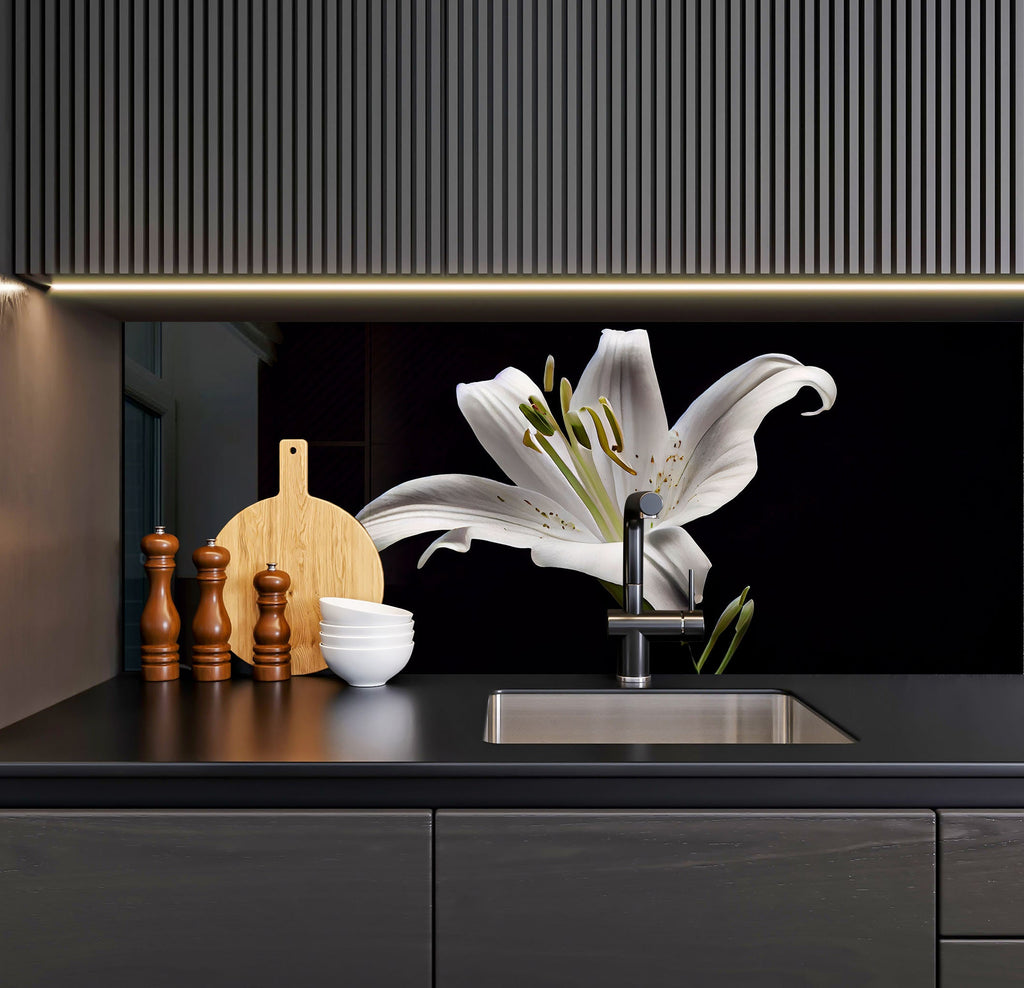 a kitchen with a sink, cutting board and a flower