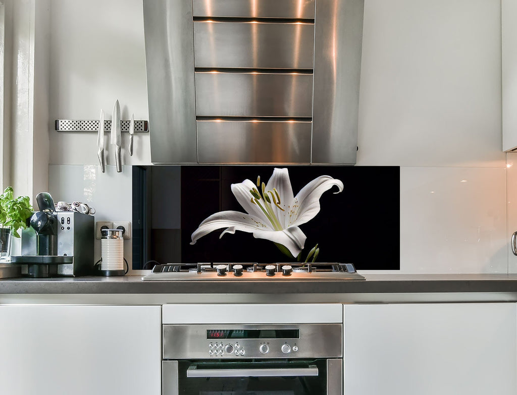 a kitchen with stainless steel appliances and a white flower