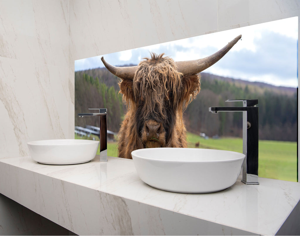 a bull with long horns standing in front of a bathroom mirror