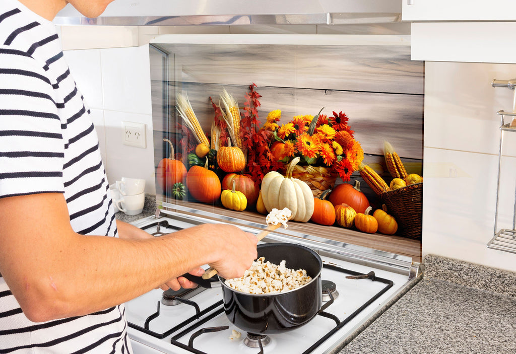 a man cooking food on a stove in a kitchen