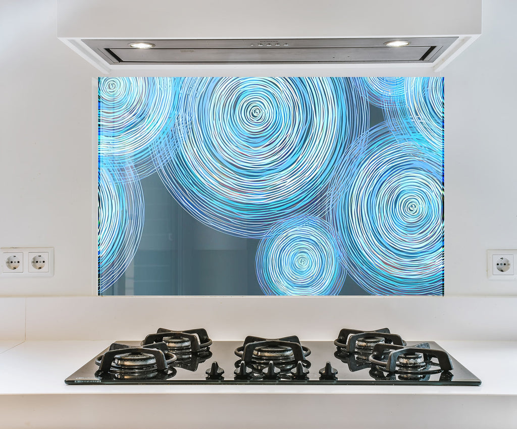 a picture of a blue swirl on a wall behind a stove