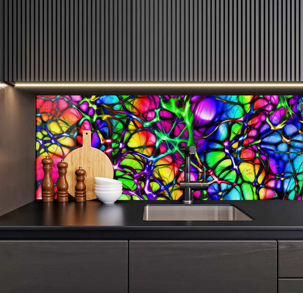 a kitchen counter with a sink and a colorful glass wall behind it