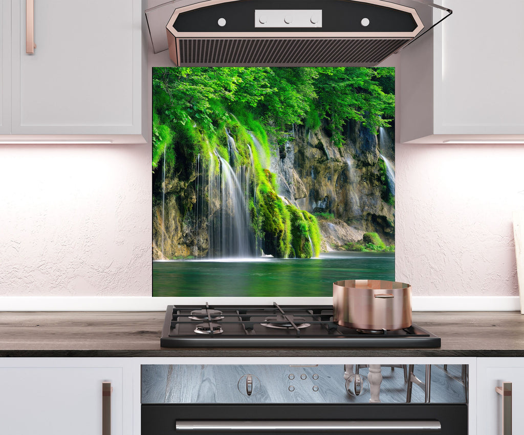 a stove top oven sitting under a picture of a waterfall