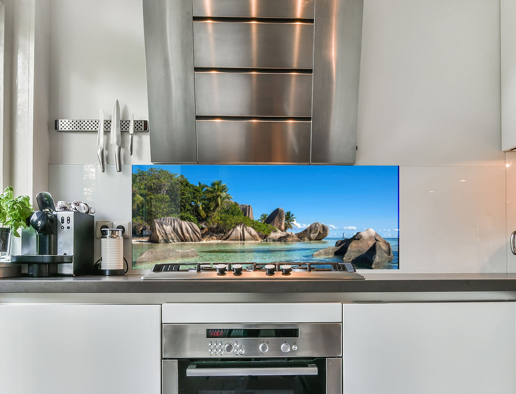 a kitchen with stainless steel appliances and a flat screen tv