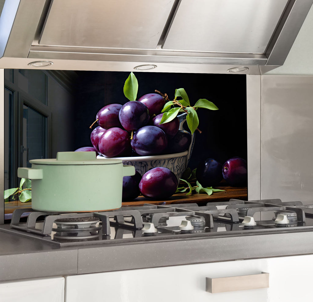 a bowl of plums sitting on top of a stove