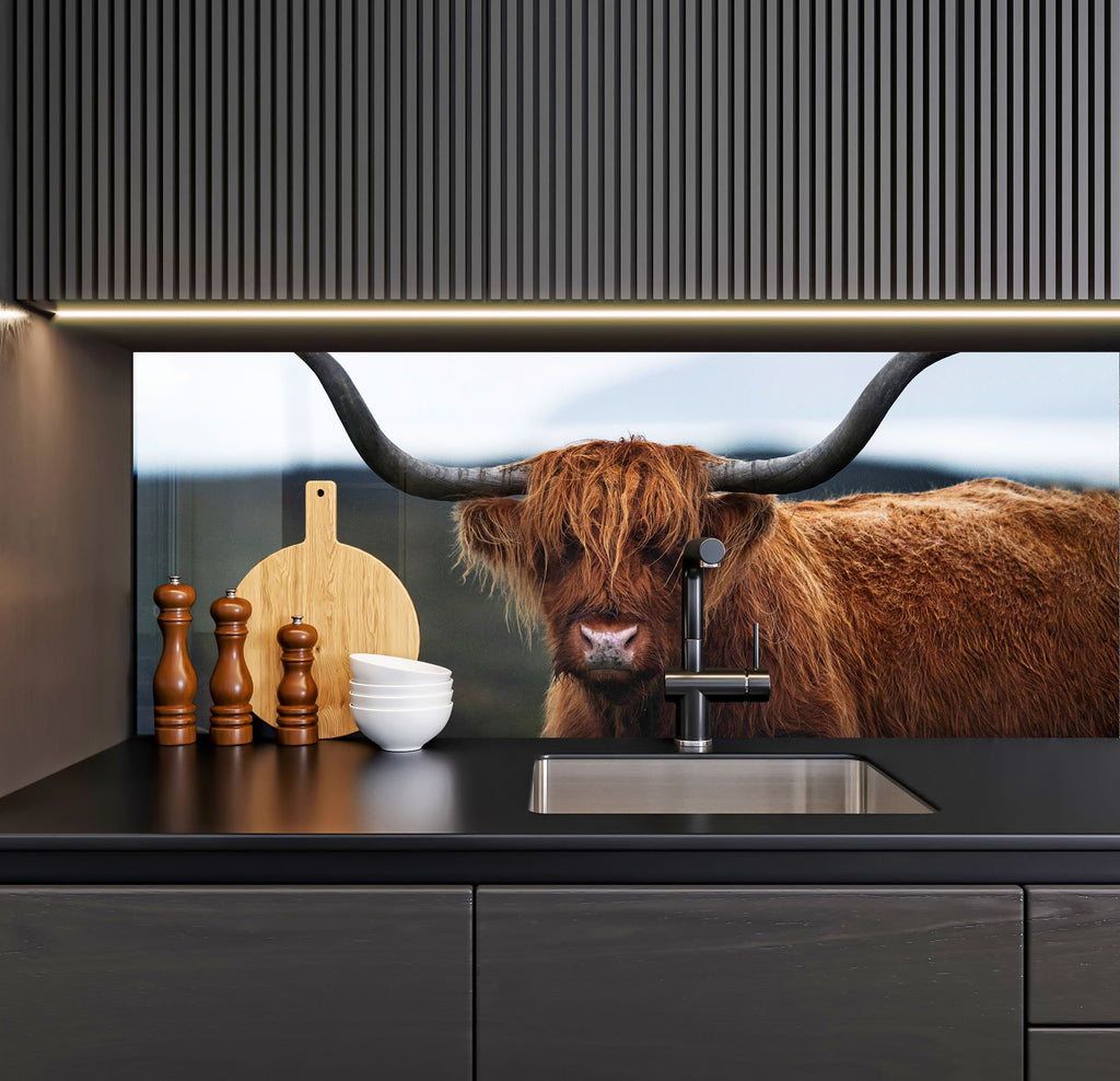 a brown cow standing next to a kitchen sink